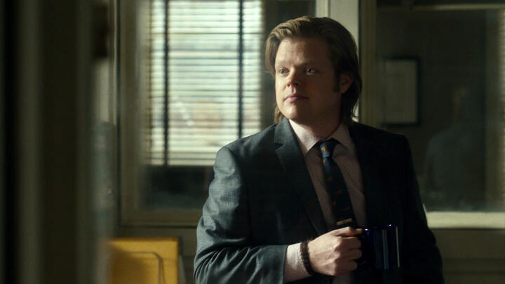 netflix foggy with long hair, smiling gently as he sits in the nelson & murdock office with a mug of coffee.